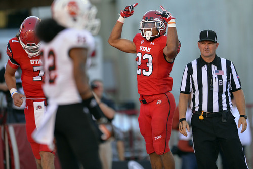 Chris Detrick  |  The Salt Lake Tribune
Utah Utes running back Devontae Booker (23) celebrates his touchdown in front of Idaho State Bengals Vai Peko (32) during the first half of the game at Rice-Eccles stadium Thursday August 28, 2014. Utah is winning the game 35-7.