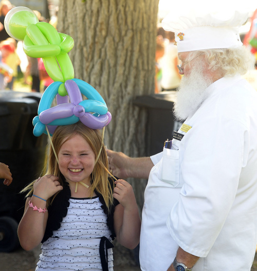 Rick Egan  |  The Salt Lake Tribune

Justice Garcia, 10, Magna, tries on a balloon, ade by Chef Hugo (MBA - Master Balloon Artist), at the Magna Labor Day Picnic, Monday, September 1, 2014