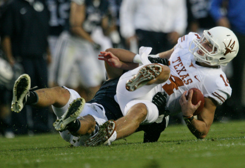 Rick Egan  | The Salt Lake Tribune 

Texas Longhorns quarterback David Ash (14) gets sacked by Brigham Young Cougars linebacker Alani Fua (5) in the Cougars 40-21 win over the University of Texas at Lavell Edwards stadium, Saturday, September 7, 2013.