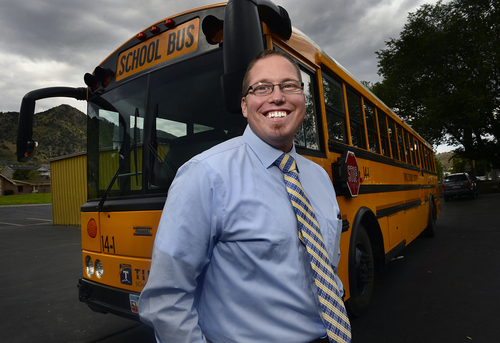 Scott Sommerdorf   |  The Salt Lake Tribune
Tintic School Superintendent Kodey Hughes stands in front of one of the district's two busses, Thursday, August 21, 2014. Hughes is one of the youngest superintendents in the state if not the youngest, and he started in the district as a special education student.