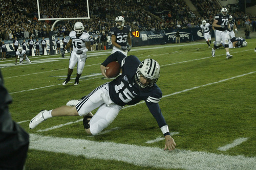 Photo by Chris Detrick  |  The Salt Lake Tribune 
Brigham Young's Max Hall #15 dives for extra yards during the first half of the game at LaVell Edwards Stadium Friday October 2, 2009. BYU is winning the game 21-7.