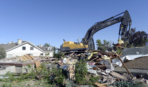 Al Hartmann  |  The Salt Lake Tribune
A last look at  former Salt Lake County home- polygamist compound of Rulon Jeffs  at 3601 E. Little Cottonwood Road. Demolition started Wednesday Sept. 3 to make way for new homes.  Large backhoe demolishes Rulon Jeffs residence the first building to go on the 4.5 acre property.  Building at left is the Alta Academy, the compound's school for FLDS children.