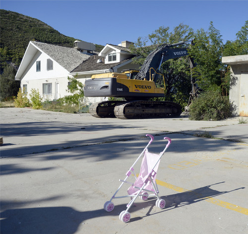 Al Hartmann  |  The Salt Lake Tribune
A last look at  former Salt Lake County home-polygamist compound of Warren and Rulon Jeffs at 3601 E. Little Cottonwood Road. Demolition started Wednesday September 3 to make way for new homes on the 4.5 acre property.  Baby stroller with backhoe ready to demolish the Alta Academy, left, where Rulon and Warren Jeffs taught FLDS children and the younger Jeffs committed some of his sex crimes.