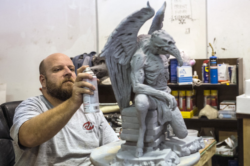 Chris Detrick  |  The Salt Lake Tribune
Cory Clawson works at painting 'Osiris' for the Evermore Adventure Park at their warehouse in Lindon Wednesday August 27, 2014.