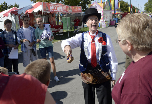 Al Hartmann  |  The Salt Lake Tribune
The Utah State Fair opens Thursday September 4, 2014. Christopher Fair gathers a crowd on the midway as he works his magic tricks on the stroll.