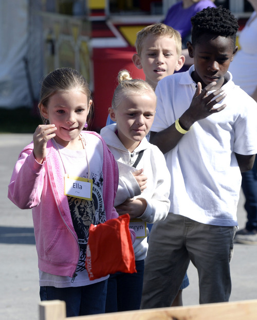 Al Hartmann  |  The Salt Lake Tribune
The Utah State Fair opens Thursday September 4, 2014.  Children toss bean bags at a game sponsored by the Utah Division of Natural Rescources.
