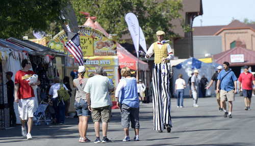 Al Hartmann  |  The Salt Lake Tribune
David Lichtenstein of Leapin Louie Comedy Shows strolls down the midway on stilts Thursday at the opening of the Utah State fair, entertaining folks as he goes with juggling and banter.