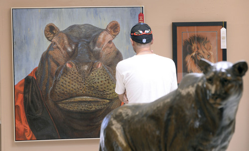 Al Hartmann  |  The Salt Lake Tribune
The Utah State Fair opens Thursday September 4, 2014. A fairgoer takes in a painting in the Fine Arts exhibit titled "heavy Weight", by Lucia Heffernan.