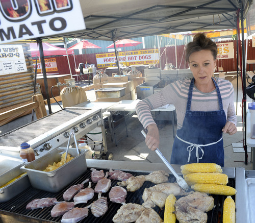 Al Hartmann  |  The Salt Lake Tribune
The Utah State Fair opens Thursday September 4, 2014. Robin Hotchkiss fires up the grill with barbequed pork chops, chicken and a new specialty,  grilled Mexican corn.