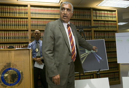 Rick Egan  | The Salt Lake Tribune 

Utah DA Sim Gill points out the angle of the fatal bullet, while discussing the findings of the investigation into the Danielle Willard fatal shooting, Thursday, August 8, 2013. Mike Powell, West Valley Police is on the right.