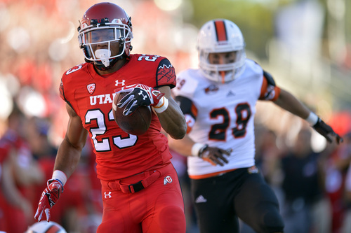 Chris Detrick  |  The Salt Lake Tribune
Utah Utes running back Devontae Booker (23) runs past Idaho State Bengals defensive back Cody Sorensen (29) during the first half of the game at Rice-Eccles stadium Thursday August 28, 2014. Utah is winning the game 35-7.