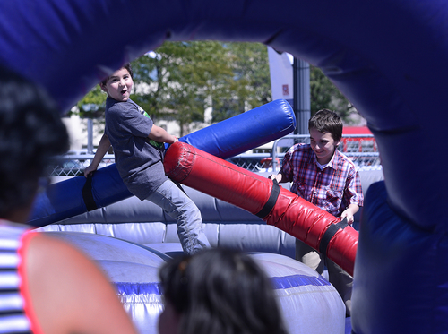 Scott Sommerdorf   |  The Salt Lake Tribune
Brothers Nicolai, 7, left, and Timmy Shrunk battle in a bounce house game at the Greek Festival, Saturday, September 6, 2014.