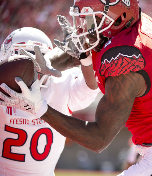 Jeremy Harmon  |  The Salt Lake Tribune

Utah's Kenneth Scott (2) catches the ball for a touchdown under pressure from Fresno State's Malcolm Washington (20) as the Utes host the Bulldogs at Rice-Eccles Stadium on Saturday, Sept. 6, 2014.