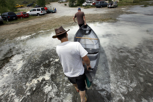 Scott Sommerdorf  l  Tribune file photo

"A Day at the Bear Lake Beach." Boaters take their canoe out of the water near Rendezvous Beach. Rendezvous Beach State Park on south end of Bear Lake, Saturday, July, 3, 2010.