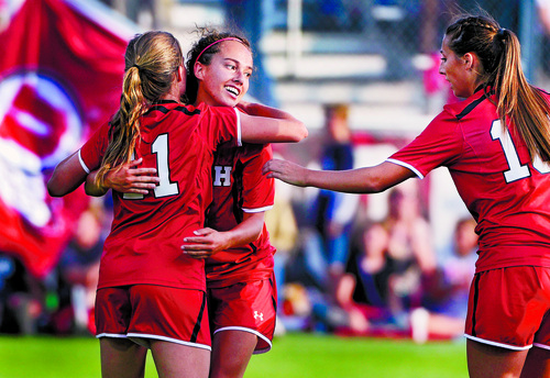 Scott Sommerdorf   |  The Salt Lake Tribune
Team mates mob Katie Taylor (#22) after she scored on a second half penalty kick, and Utah women's soccer defeated BYU 1-0 in Salt Lake City, Friday, September 5, 2014.