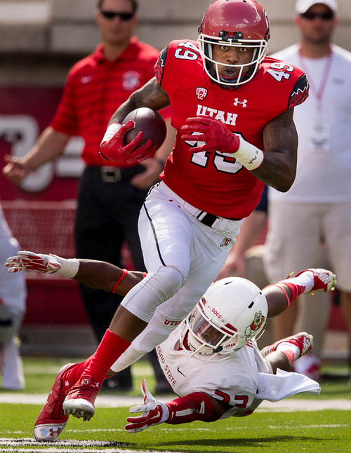 Trent Nelson  |  The Salt Lake Tribune
Utah Utes wide receiver Andre Lewis (49) avoids a Fresno State defender, en route to a touchdown, as Utah hosts Fresno State, college football at Rice-Eccles Stadium Saturday September 6, 2014.