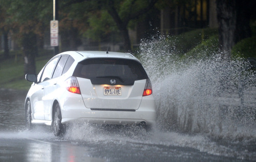 Al Hartmann  |  The Salt Lake Tribune
Cars send up rooster tails going up State Street in Salt Lake City Tuesday morning Septmeber  9 from overwelmed storm drains during this morning's intense rainstorm.