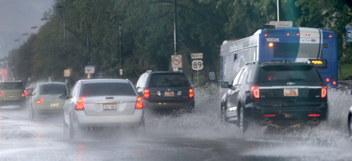Al Hartmann  |  The Salt Lake Tribune
Cars send up rooster tails going up State Street in Salt Lake City Tuesday morning Septmeber  9 from overwelmed storm drains during this morning's intense rainstorm.