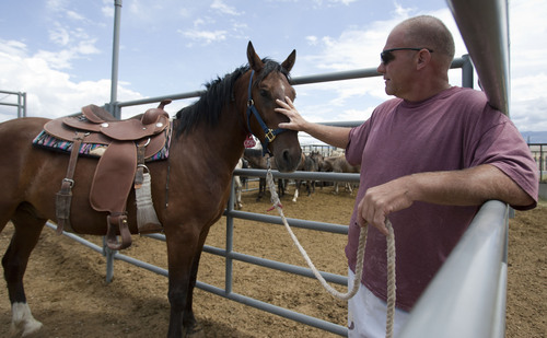 Photo by Jim Urquhart  |  The Salt Lake Tribune

An inmate works with a four-year-old horse named Boone at the Horse Gentling Program Thursday, July 29, 2010 at the Utah State Prison in Gunnison. The Utah State Prison in Gunnison has a program in which inmates gentle and train mustangs brought in from BLM land so the mustangs can be adopted out. 2010.