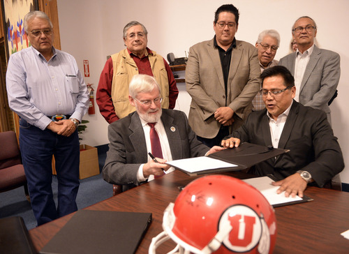 Al Hartmann  |  The Salt Lake Tribune
David W. Pershing, University of Utah president, front left, and Gordon Howell, chairman of the Ute Indian Tribe Business Committee sign a memorandum of understanding on Tuesday outlining the Universityís continued use of the Ute name for its athletics teams as members of the Ute Business Committe watch the signing at a ceremony at Fort Duchesne.