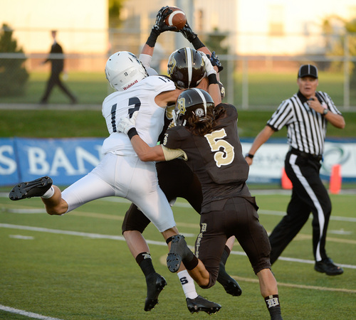 Francisco Kjolseth  |  The Salt Lake Tribune
Davis High's Tyler Hinds pulls in a pass intended for Syracuse in game action at Davis in Kaysville on Thursday, Sept. 11, 2014.