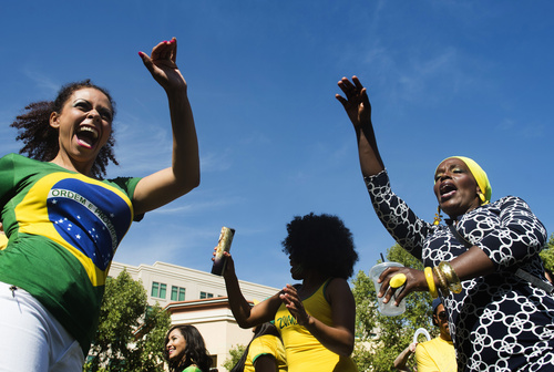 Rick Egan  |  The Salt Lake Tribune
Vanubia Séller, left, Nisia Payne, and Tânia Buiza, dance at the 10th Annual Utah Brazilian Festival at the Gateway on Saturday.  The festival features the best of Brazilian arts, culture, music and cuisine, along with face painting, capoeira.