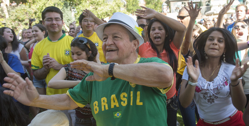 Rick Egan  |  The Salt Lake Tribune

Robert Gonzales (center) dances to Brazilian music along with Diana Singh (right), at the10th Annual Utah Brazilian Festival at the Gateway, Saturday, September 13, 2014.  The festival features the best of Brazilian arts, culture, music and cuisine, along with face painting, capoeira.