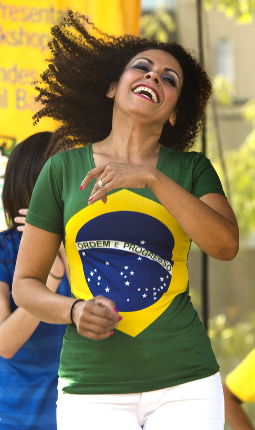 Rick Egan  |  The Salt Lake Tribune

Vanubia Séller dances at the 10th Annual Utah Brazilian Festival at the Gateway, Saturday, September 13, 2014.  The festival features the best of Brazilian arts, culture, music and cuisine, along with face painting, capoeira.
