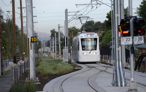 Al Hartmann  |  The Salt Lake Tribune 
The Sugar House streetcar nears the end of the line at Fairmont Park Wednesday August 13, 2014.  It is only slightly faster than the nearby parallel bus, and pedestrians sometimes can outrace it. Far fewer people than projected are riding it. And it was expensive, $37 million. But officials still see it as a success and worth the price because of the economic development it has attracted.