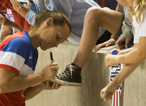 Rick Egan  |  The Salt Lake Tribune

Christie Rampone (3) signs her autograph for a young fan after the  U.S. Women's National Team defeated Mexico 8-0,  Saturday, September 13, 2014