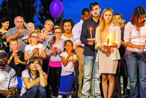 Trent Nelson  |  The Salt Lake Tribune
Susan Hunt, lower left, listens to stories about her son, Darrien Hunt, at a candlelight vigil Sunday September 14, 2014 for Darrien, who was shot and killed by Saratoga Springs police.