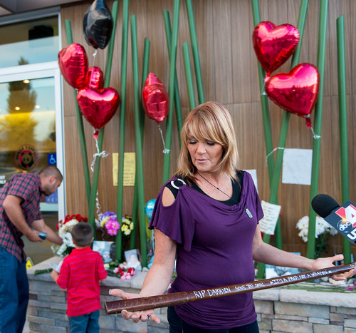 Trent Nelson  |  The Salt Lake Tribune
Cindy Moss, Darrien Hunt's aunt, holds a wooden sword at a memorial to Darrien Sunday September 14, 2014 at the Saratoga Springs Panda Express where Hunt was shot and killed by police.