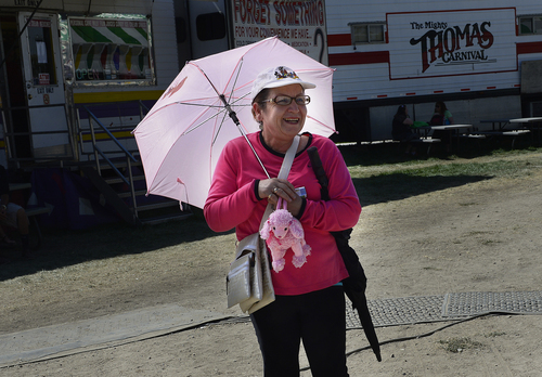 Scott Sommerdorf   |  The Salt Lake Tribune
Lupe Araujo is fully set up in pink as she waits for family on the midway during the final day of the Utah State Fair, Sunday, September 14, 2014.