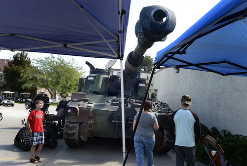 Scott Sommerdorf   |  The Salt Lake Tribune
Fair visitors examine a huge m109a6 "Paladin" self-propelled howitzer at the National Guard booth during the final day of the Utah State Fair, Sunday, September 14, 2014.