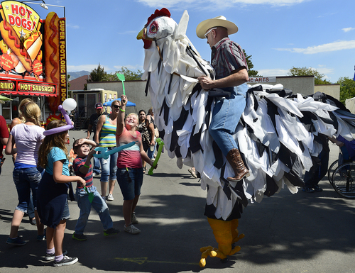 Scott Sommerdorf   |  The Salt Lake Tribune
Young fair visitors joust with "Salt and Pepper" a giant chicken, during the final day of the Utah State Fair, Sunday, September 14, 2014.