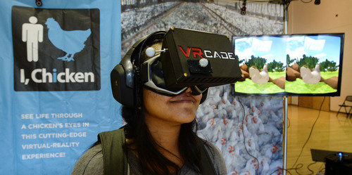 Steve Griffin  |  The Salt Lake Tribune
University of Utah student, Faane Malafu, participates in PETA's youth division high-tech "I, Chicken" virtual reality (VR) hardware exhibit at the University of Utah Union in Salt Lake City, Monday, September 15, 2014.  The exhibit includes wireless VR goggles, motion capture cameras, and a powerful computerówith guidance from leading VR psychologists in order to immerse participants in a world where they can flap their wings, communicate with other chickens, take dust baths, and engage in other natural chicken behavior.