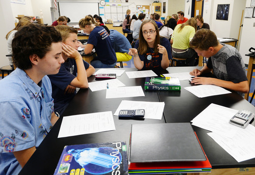 Steve Griffin  |  The Salt Lake Tribune


Sarah Carlson,works with her physics students during class at Brighton High School in Cottonwood Heights, Utah Friday, August 22, 2014. More Utah teachers are flipping their classrooms -- having kids learn via technology at home and then do their "homework" during class with help from the teacher.