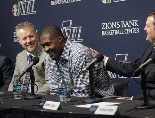 Al Hartmann  |  The Salt Lake Tribune
Dennis Lindsey, Utah Jazz general manager, right, congratulates power forward Derrick Favors, on his new multi-year contract extension during a press conference Monday October 28, 2013 in Salt Lake City. Jazz owner, Greg Miller, is at left.