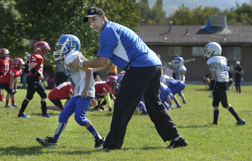 Scott Sommerdorf   |  The Salt Lake Tribune
Brandon Doman, former BYU offensive coordinator, repositions a player on defense as he coaches a fourth-grade football team - The  Pleasant Grove Vikings, in their game versus American Fork, Saturday, September 13, 2014.