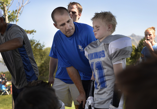 Scott Sommerdorf   |  The Salt Lake Tribune
Brandon Doman, former BYU offensive coordinator, talks with his son Jace Doman after the fourth-grade football team's first loss of the season, Saturday, September 13, 2014. Doman coaches The  Pleasant Grove Vikings.