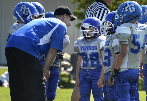 Scott Sommerdorf   |  The Salt Lake Tribune
The  Pleasant Grove Vikings, a fourth-grade football team listens to Brandon Doman, former BYU offensive coordinator, as he coaches them during their game versus American Fork, Saturday, September 13, 2014.