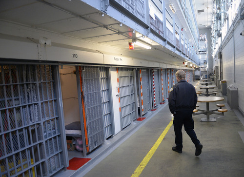 Al Hartmann  |  The Salt Lake Tribune 
Utah Department of Corrections officer walks through the medium security Wasatch A block at the Utah State Prison in Draper.  It's among the oldest buildings at the prison, built in the early 1950's.