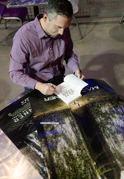 Francisco Kjolseth  |  The Salt Lake Tribune
Utah writer James Dashner, whose book, "The Maze Runner," is opening as a Hollywood blockbuster on Sept. 19, signs a few posters and a copy of his book as he stops by one of his regular spots, The District Movie Theatre near his home in South Jordan.
