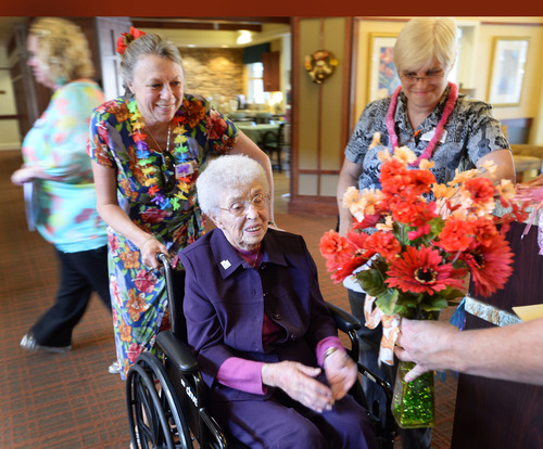 Steve Griffin  |  The Salt Lake Tribune


Lou Calder, a long-time resident at The Wellington Senior Living, receives a bouquet of flowers during her 105th birthday celebration at the senior living center in Salt Lake City, Utah Wednesday, September 17, 2014.  Calder was celebrating her birthday during a Luau party at the center.  Calder was born in 1909 and grew up near Bear Lake, Utah, where she enjoyed golfing, sailing and raspberry milkshakes. Lou says longevity runs in her family and credits her long life to having a positive attitude and living a healthy lifestyle. She was also presented with birthday congratulation certificates from President Barack Obama and Governor Gary Herbert.