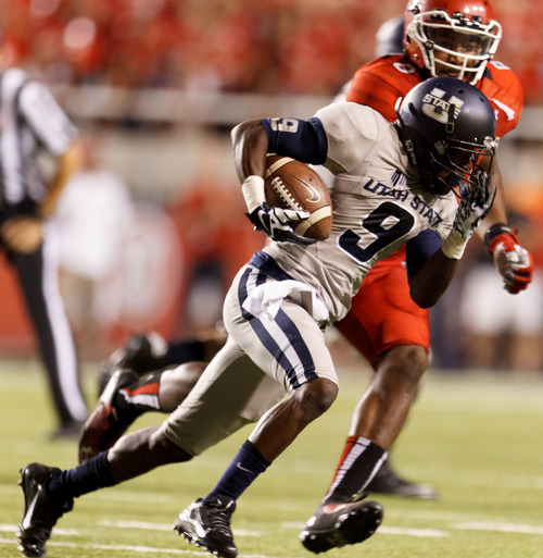 Trent Nelson  |  The Salt Lake Tribune
Utah State Aggies wide receiver Bruce Natson (9) is chased down by Utah Utes defensive end Nate Orchard (8) as the University of Utah hosts Utah State, college football Thursday, August 29, 2013 at Rice-Eccles Stadium in Salt Lake City.