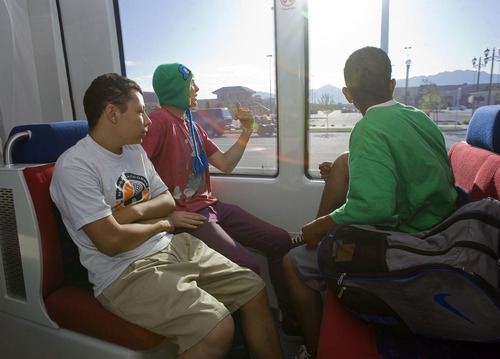 Al Hartmann  |  The Salt Lake Tribune
Friends Jorge Bocar, left, Joshua Jankowsky and Laffaette Outlaw take in the sights near the Valley Fair Mall in West Valley City on Monday, Aug. 8, 2011, on an early morning TRAX train along the Green line. They boarded an early TRAX in Salt Lake City and were going to ride all the lines of the system to see the Salt Lake Valley.