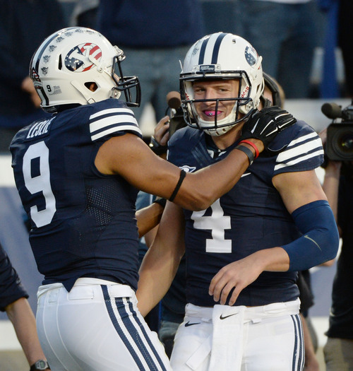 Steve Griffin  |  The Salt Lake Tribune


BYU Cougars quarterback Taysom Hill (4) is congratulated by teammate BYU Cougars wide receiver Jordan Leslie (9) after Hill ran for a touchdown during game between BYU and Houston and LaVell Edwards Stadium in Provo, Thursday, September 11, 2014.
