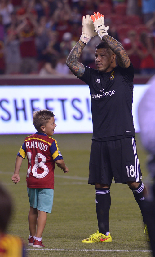 Leah Hogsten  |  The Salt Lake Tribune
Real Salt Lake goalkeeper Nick Rimando (18) celebrates his new MLS record for career game shutouts at 113 with his son Jet. 
Real Salt Lake defeated D. C. United 3-0 Saturday, August 9, 2014, at Rio Tinto Stadium.