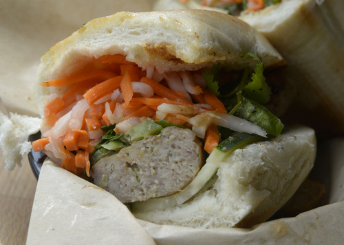 Al Hartmann  |  The Salt Lake Tribune
Zao Asian Cafe's banh mi sandwich with house-made chicken or pork meatballs comes with chile-lime aioli, house hoisin and choice of vegetables and toppings.  It's a lunch crowd favorite.