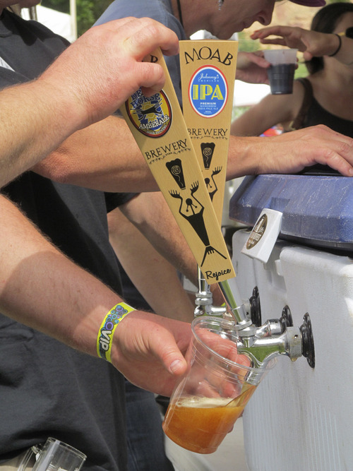Nate Carlisle  |  The Salt Lake Tribune
Gary Ranch pours a brew at the first Moab Beer Festival on Saturday May 24, 2014.